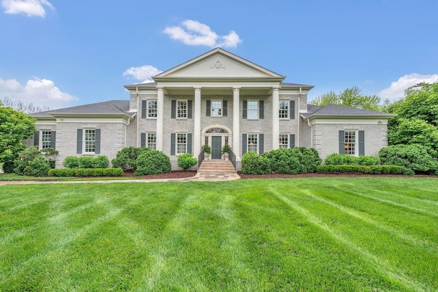 neoclassical / greek revival house with a front lawn