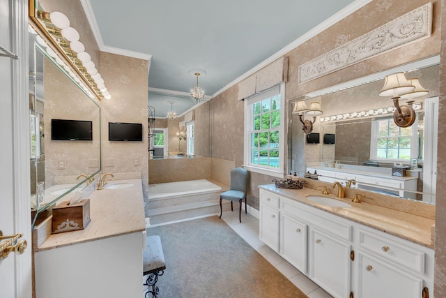 bathroom with crown molding, two vanities, tile patterned floors, a garden tub, and a chandelier