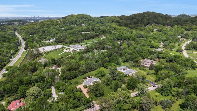 aerial view of property and surrounding area featuring a forest