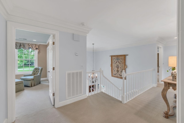 hallway with carpet floors, a chandelier, crown molding, an upstairs landing, and baseboards