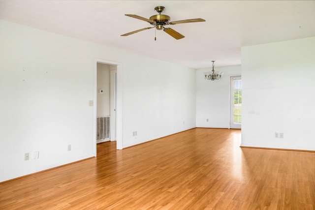 4170 Dot Rd, Springfield, TN 37172 - empty room with a chandelier, light wood-style flooring, ceiling fan, and baseboards