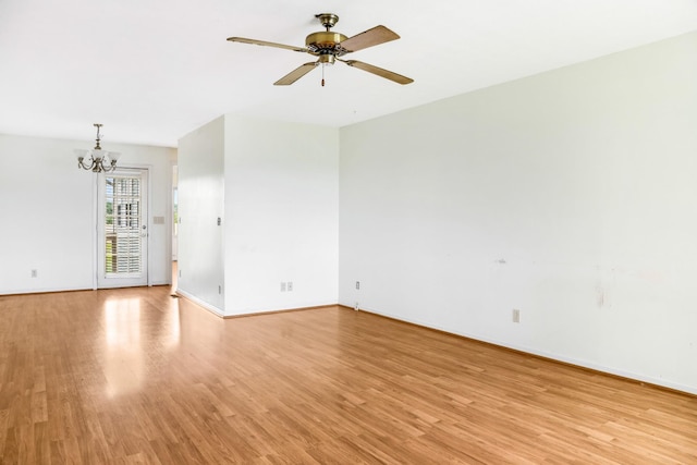 4170 Dot Rd, Springfield, TN 37172 - empty room with a chandelier, light wood finished floors, baseboards, and a ceiling fan