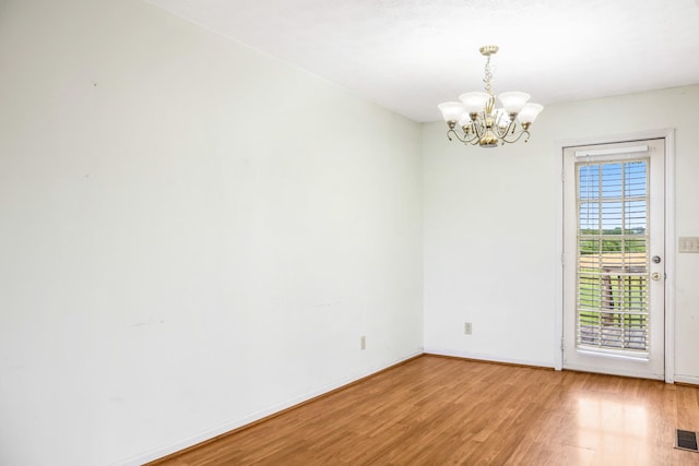 4170 Dot Rd, Springfield, TN 37172 - unfurnished room with a chandelier, light wood-style floors, and baseboards