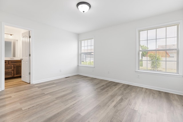 unfurnished bedroom featuring light wood finished floors and baseboards
