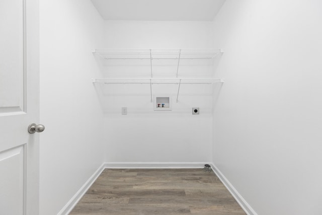 clothes washing area with washer hookup, wood finished floors, electric dryer hookup, and baseboards