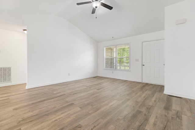 unfurnished room with lofted ceiling, a ceiling fan, light wood-type flooring, and baseboards