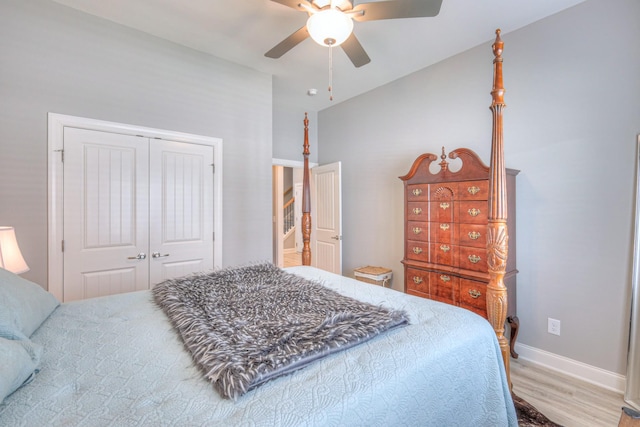 bedroom featuring wood finished floors, a closet, baseboards, and a ceiling fan