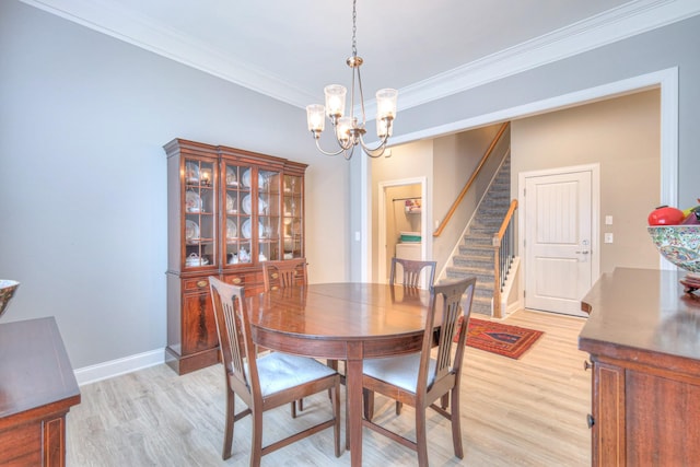 dining space featuring light wood-style floors, a chandelier, stairway, crown molding, and baseboards