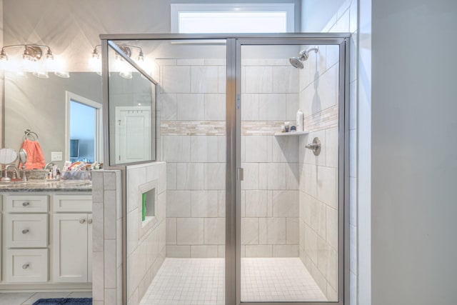 bathroom featuring a stall shower and vanity