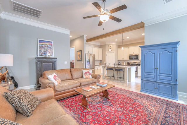 living area with ceiling fan, light wood-style floors, recessed lighting, crown molding, and a fireplace