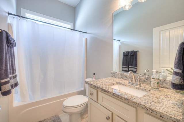 bathroom featuring vanity, shower / bathtub combination with curtain, and toilet