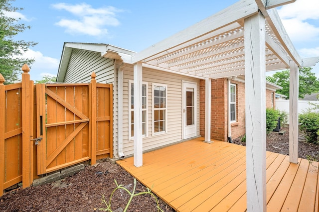 wooden terrace with a gate, a pergola, and fence