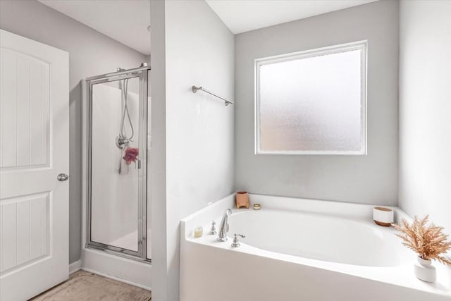 full bath with a shower stall and a bath