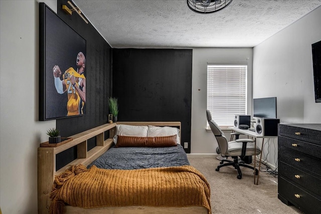 bedroom featuring carpet, a desk, and a textured ceiling
