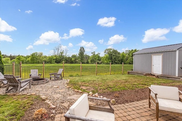 view of yard featuring an outdoor fire pit, a patio area, a shed, and an outdoor structure
