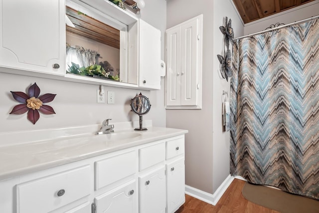 6966 Park Dr, Lyles, TN 37098 - full bathroom with wood finished floors, vanity, baseboards, and a shower with shower curtain