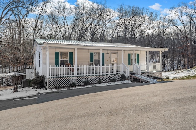 6966 Park Dr, Lyles, TN 37098 - view of front facade with covered porch, metal roof, and central air condition unit