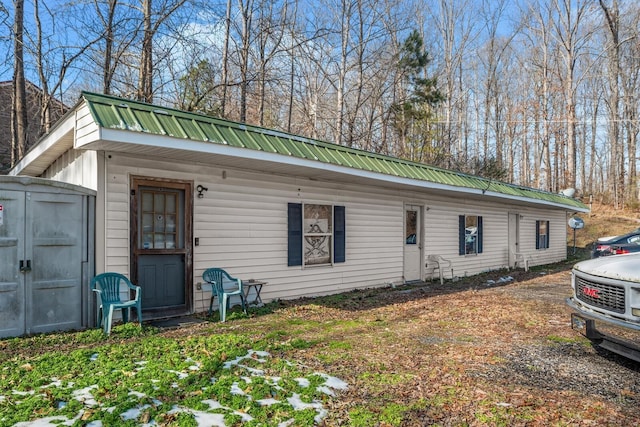6966 Park Dr, Lyles, TN 37098 - view of front of property featuring metal roof, a storage shed, and an outdoor structure