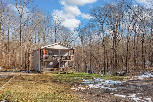 6966 Park Dr, Lyles, TN 37098 - view of front facade with a deck, stairs, a front yard, and a forest view