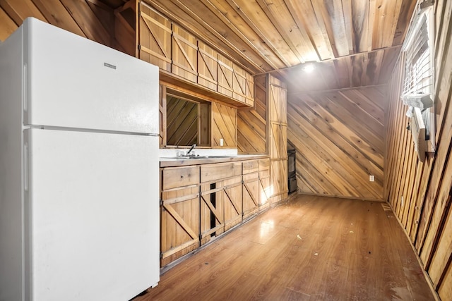 6966 Park Dr, Lyles, TN 37098 - kitchen with freestanding refrigerator, a sink, wood walls, light wood-type flooring, and wood ceiling