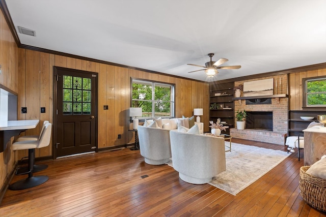 1511 Bunker Hill Dr, Chattanooga, TN 37421 - living room with healthy amount of natural light, ornamental molding, wood walls, hardwood / wood-style flooring, and a ceiling fan