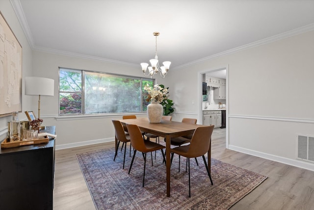 1511 Bunker Hill Dr, Chattanooga, TN 37421 - dining room featuring a chandelier, light wood-type flooring, ornamental molding, and baseboards