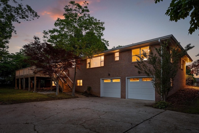 1511 Bunker Hill Dr, Chattanooga, TN 37421 - view of front of house with driveway, an attached garage, a deck, brick siding, and stairs