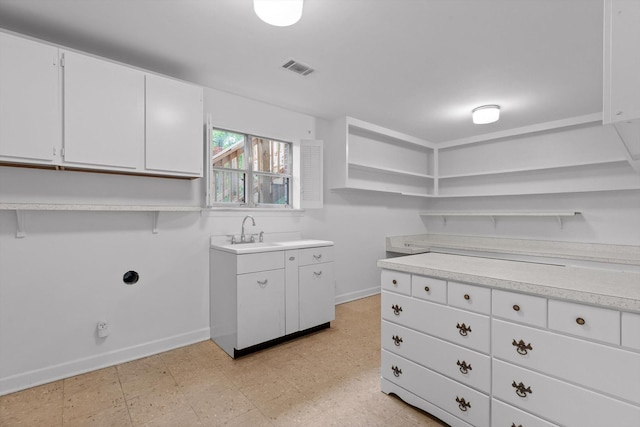 1511 Bunker Hill Dr, Chattanooga, TN 37421 - kitchen featuring open shelves, a sink, white cabinetry, light countertops, and light floors