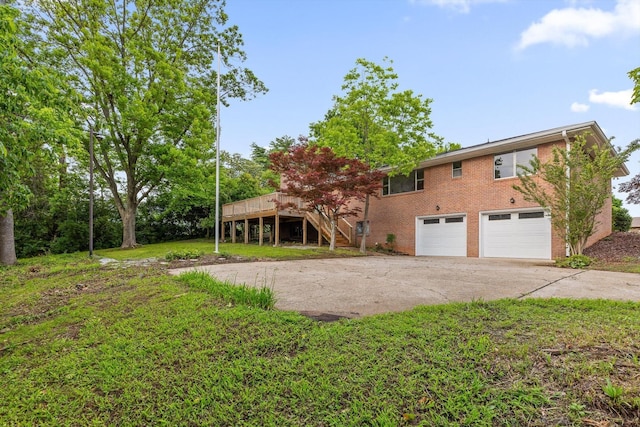 1511 Bunker Hill Dr, Chattanooga, TN 37421 - view of front of property featuring concrete driveway, an attached garage, stairs, brick siding, and a wooden deck
