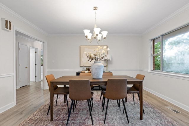 1511 Bunker Hill Dr, Chattanooga, TN 37421 - dining room with wood finished floors, a chandelier, crown molding, and baseboards