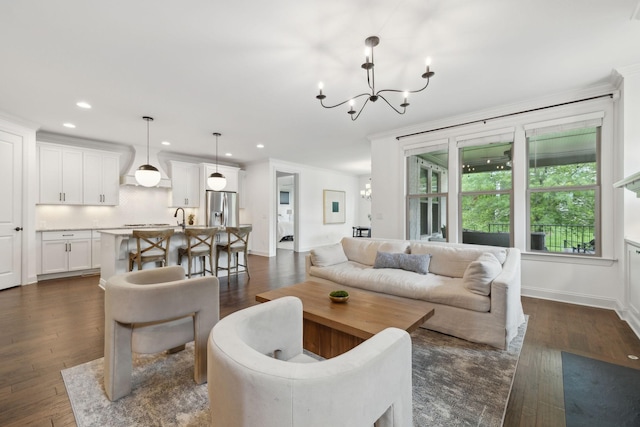 1022 Echelon Dr, Franklin, TN 37064 - living room with a chandelier, recessed lighting, ornamental molding, dark wood finished floors, and baseboards