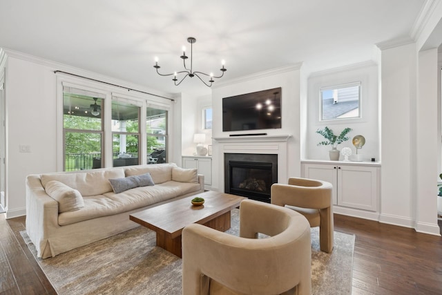 1022 Echelon Dr, Franklin, TN 37064 - living area with crown molding, a chandelier, dark wood finished floors, plenty of natural light, and a glass covered fireplace
