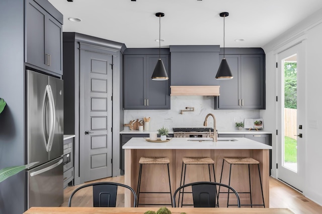 517B River Rouge Dr, Nashville, TN 37209 - kitchen featuring stainless steel fridge, a sink, light countertops, a breakfast bar, and recessed lighting