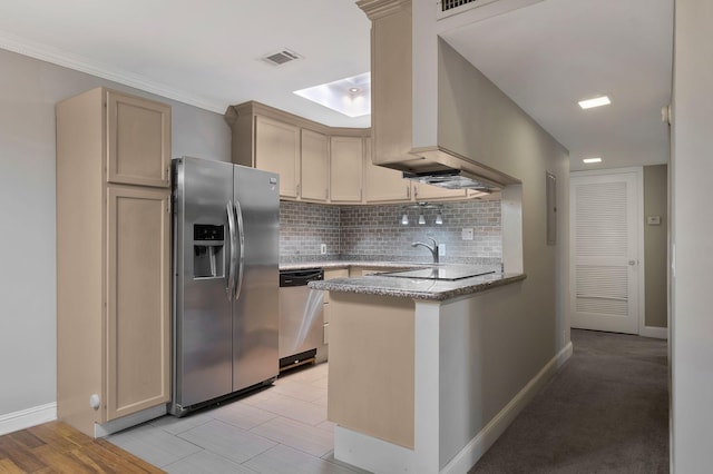 kitchen featuring appliances with stainless steel finishes, a peninsula, tasteful backsplash, light stone counters, and baseboards