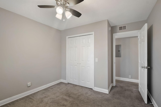 unfurnished bedroom with carpet, baseboards, a closet, and a ceiling fan