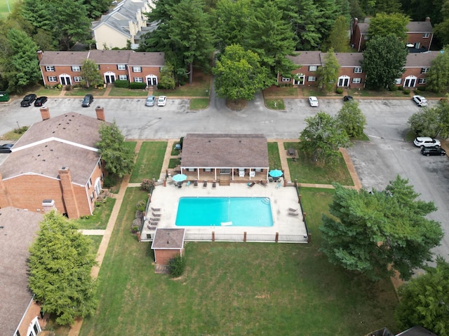 aerial view of property's location with a pool area and nearby suburban area