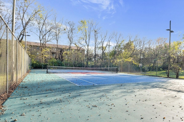 view of tennis court with fence