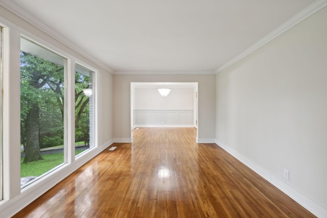909 Plateau Pkwy, Nashville, TN 37205 - empty room featuring plenty of natural light, hardwood / wood-style floors, crown molding, a chandelier, and baseboards