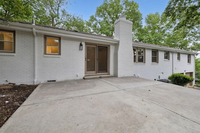 909 Plateau Pkwy, Nashville, TN 37205 - rear view of house featuring a chimney, brick siding, and a patio area