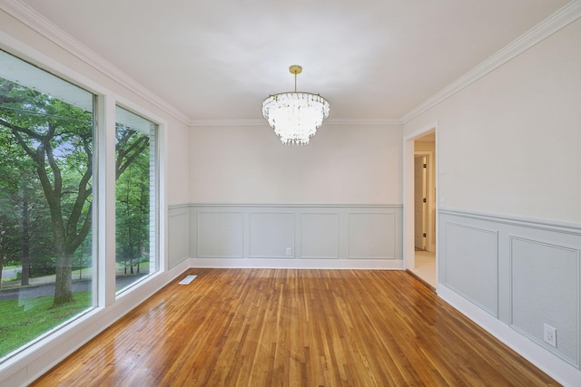 909 Plateau Pkwy, Nashville, TN 37205 - spare room with healthy amount of natural light, a chandelier, wood-type flooring, ornamental molding, and wainscoting