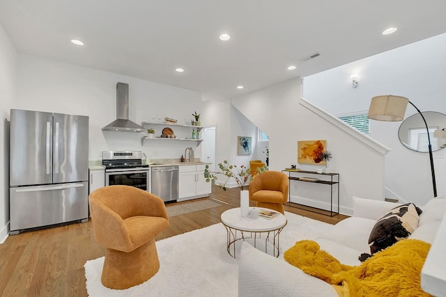 1056E 2nd Ave S, Nashville, TN 37210 - living area with light wood-style flooring, stairway, and recessed lighting