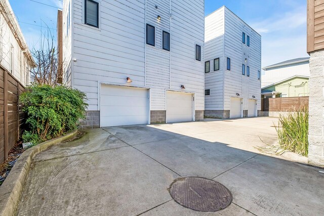 1056E 2nd Ave S, Nashville, TN 37210 - view of property exterior featuring an attached garage, concrete driveway, and fence