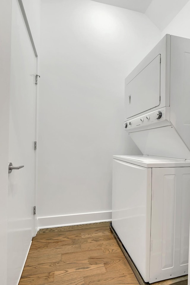1056E 2nd Ave S, Nashville, TN 37210 - clothes washing area featuring stacked washing machine and dryer, light wood-type flooring, and baseboards
