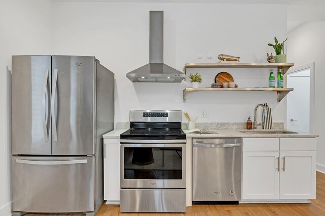 1056E 2nd Ave S, Nashville, TN 37210 - kitchen with appliances with stainless steel finishes, a sink, extractor fan, white cabinetry, and light wood-type flooring