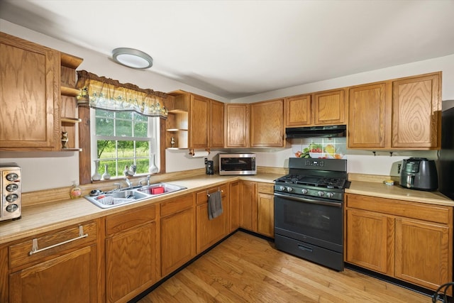 747 Hunting Creek Rd, Whitleyville, TN 38588 - kitchen with open shelves, black gas range oven, under cabinet range hood, stainless steel microwave, and a sink