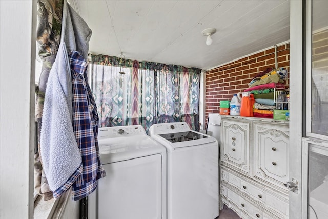 747 Hunting Creek Rd, Whitleyville, TN 38588 - clothes washing area with washer and dryer, brick wall, and cabinet space