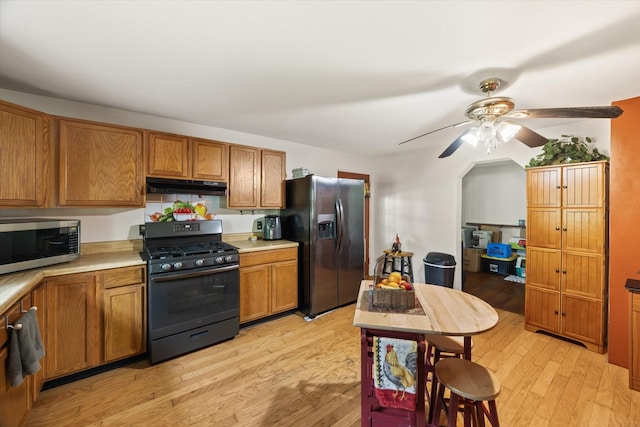 747 Hunting Creek Rd, Whitleyville, TN 38588 - kitchen featuring black appliances, under cabinet range hood, a ceiling fan, and brown cabinetry
