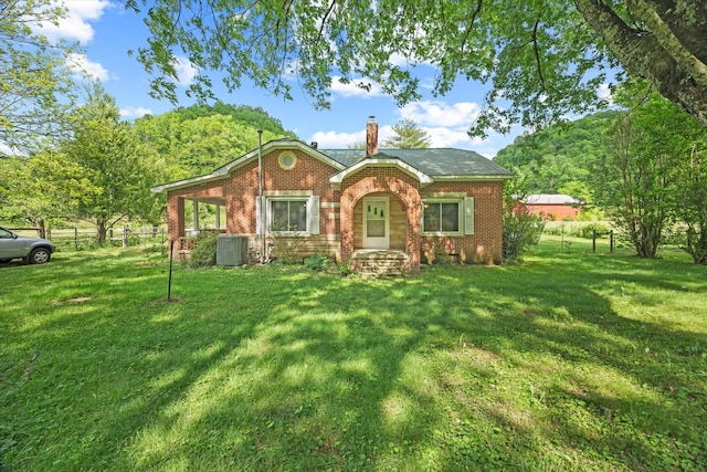 747 Hunting Creek Rd, Whitleyville, TN 38588 - view of front of property with a chimney, brick siding, and cooling unit