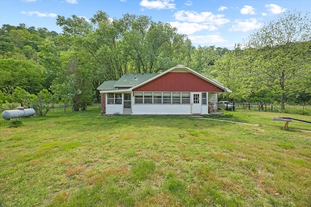 747 Hunting Creek Rd, Whitleyville, TN 38588 - rear view of property with a sunroom, a wooded view, and metal roof
