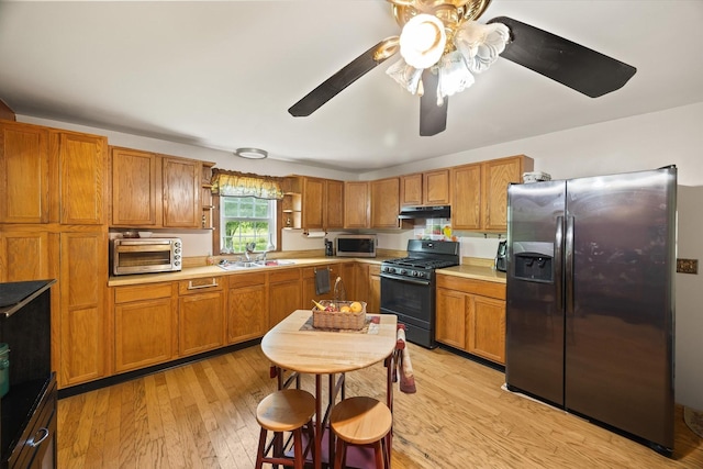 747 Hunting Creek Rd, Whitleyville, TN 38588 - kitchen with appliances with stainless steel finishes, under cabinet range hood, open shelves, and brown cabinets